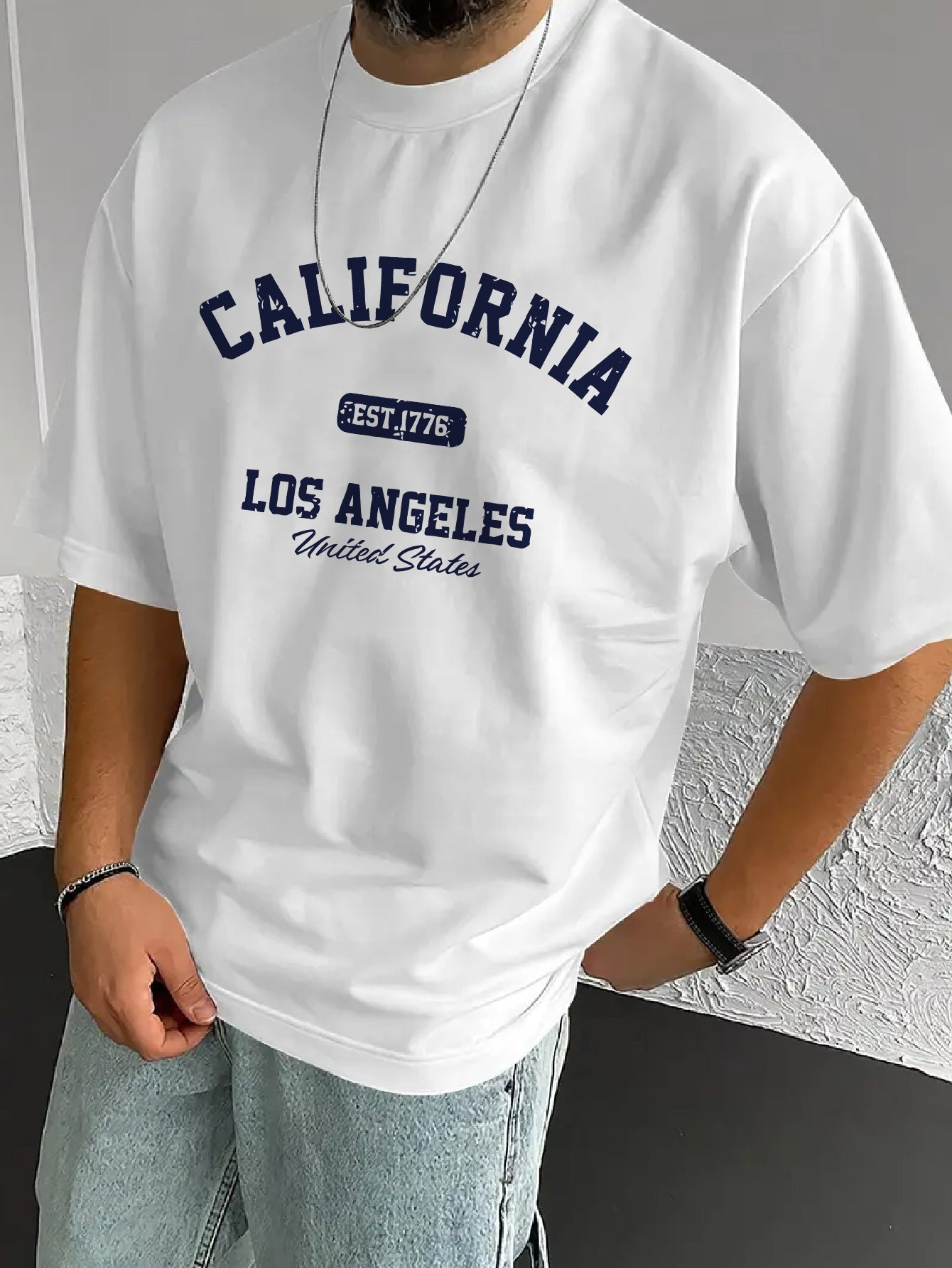 A Stylish Loose-Fitting White T-Shirt for Men with a Trendy Letter Print, Perfect for Casual Wear.